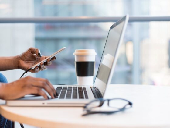 person using macbook air on table