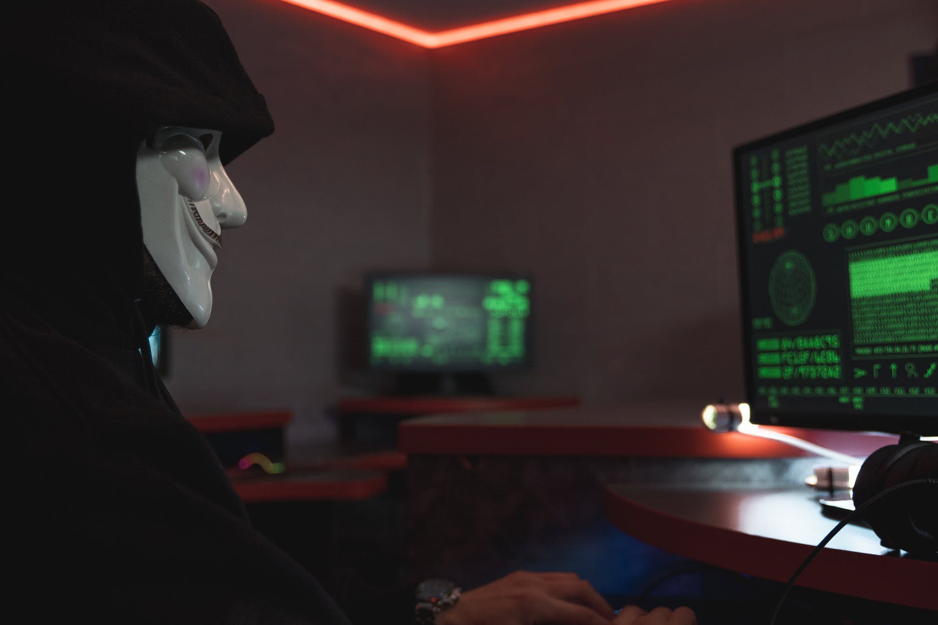 une personne avec un masque utilisant un ordinateur