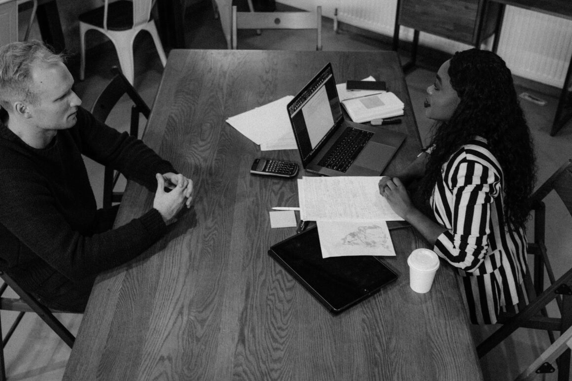 woman in black and white long sleeve shirt sitting on chair