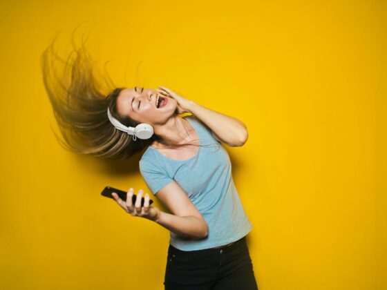 photography of woman listening to music