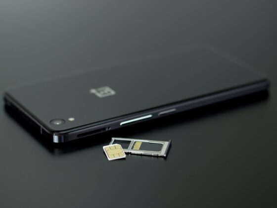 black smartphone on black table top