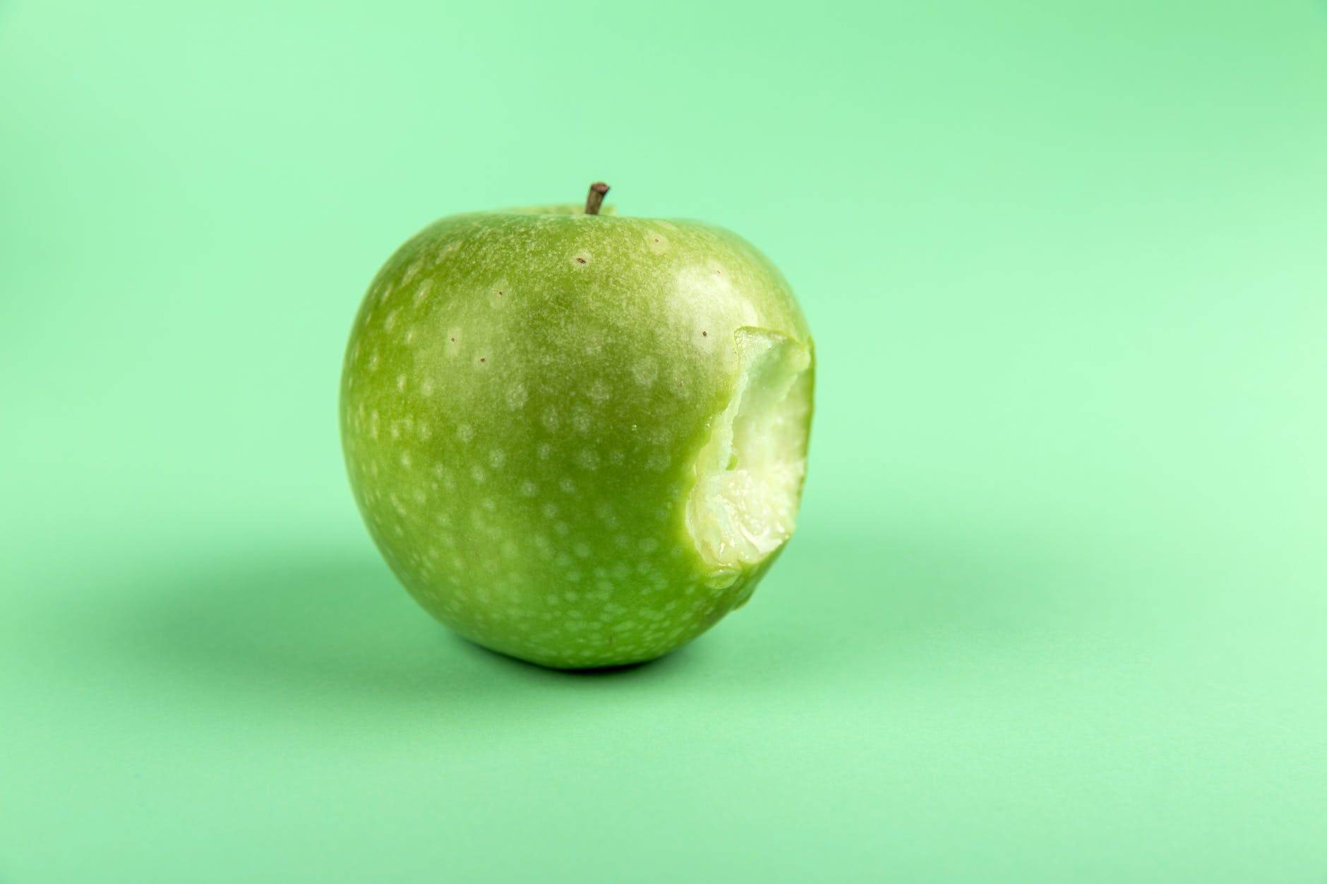 grannysmith apple with bite