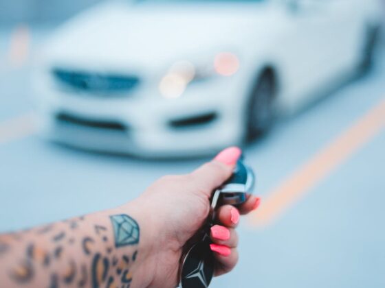 faceless person using transponder while opening car