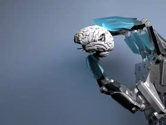 Un cerveau tenu par une main bionique
