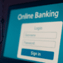 Un hameçon suspendu devant un écran d’ordinateur affichant une page de connexion à une banque en ligne. L’image illustre une tentative de phishing en ligne dans un contexte sobre et moderne, avec un contraste visuel fort pour attirer l’attention sur le risque.