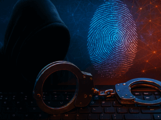 Image symbolique d'une cybercriminalité, montrant une silhouette encapuchonnée derrière un clavier d’ordinateur, des menottes métalliques posées sur les touches, et une empreinte digitale numérique lumineuse en arrière-plan sur fond de réseau digital orange et bleu. L’image évoque le piratage informatique, les arrestations de cybercriminels et l’identification numérique.