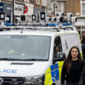 Un van de la police britannique équipé de caméras de reconnaissance faciale surveillant une foule dans une rue.