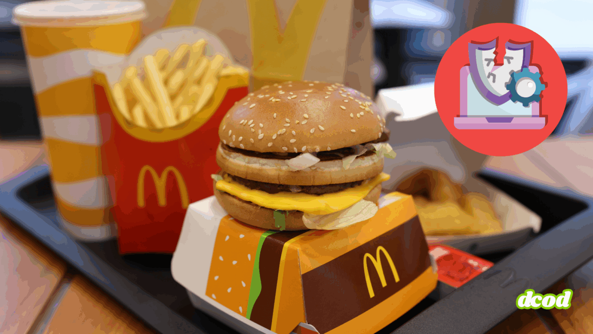 Plateau-repas McDonald's comprenant un cheeseburger, des frites, une boisson et des nuggets, avec une icône de cybersécurité brisée en surimpression, symbolisant une faille informatique ou un piratage dans le contexte de la restauration rapide.