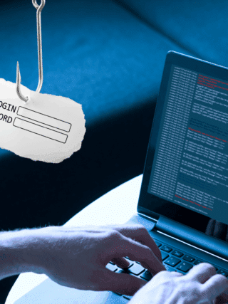 Un développeur tapant sur un ordinateur portable avec un écran affichant du code, tandis qu’un hameçon suspend un papier portant les champs « Login » et « Password », illustrant une attaque de phishing informatique.