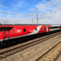 Train à grande vitesse rouge et gris de la compagnie LNER (London North Eastern Railway) circulant sur une voie ferrée électrifiée par une journée ensoleillée, au milieu d’un paysage rural britannique.