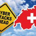 Cyberattaques : la Suisse monte au neuvième rang européen des pays les plus ciblés 9 Panneau jaune de signalisation indiquant « Cyber Attacks Ahead » à côté d'une carte rouge de la Suisse avec une croix blanche, sur fond de ciel nuageux, symbolisant les alertes face aux cybermenaces dans le pays.