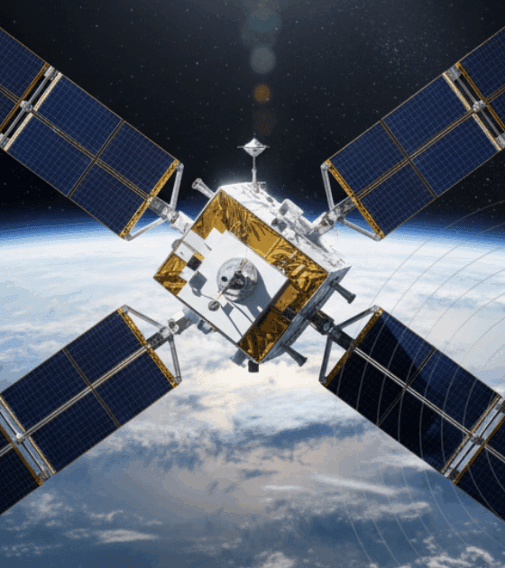 Vue en haute résolution d’un satellite d’observation équipé de quatre grands panneaux solaires orientés en croix, flottant en orbite au-dessus de la Terre, avec la courbure de la planète et l’espace en arrière-plan.