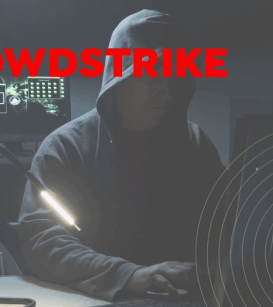 Une personne encapuchonnée devant plusieurs écrans dans une pièce sombre, symbolisant une compromission interne liée au partage de données sensibles.