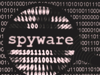 Image montrant le mot « spyware » agrandi au centre d’un fond composé de lignes de code en binaire floues, évoquant une surveillance numérique et l’analyse de données. Un motif circulaire rappelle une cible ou un radar, avec un logo « dcod » en bas à droite.