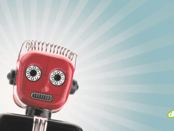 Petit robot rouge au style vintage, incliné vers la gauche, sur fond bleu clair avec des rayons lumineux stylisés.