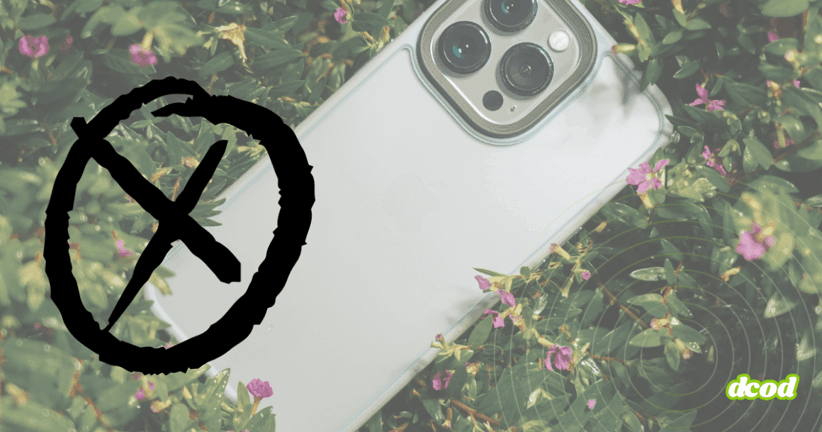 Un smartphone clair partiellement entouré de plantes, recouvert d’un large symbole noir en forme de cercle barré.