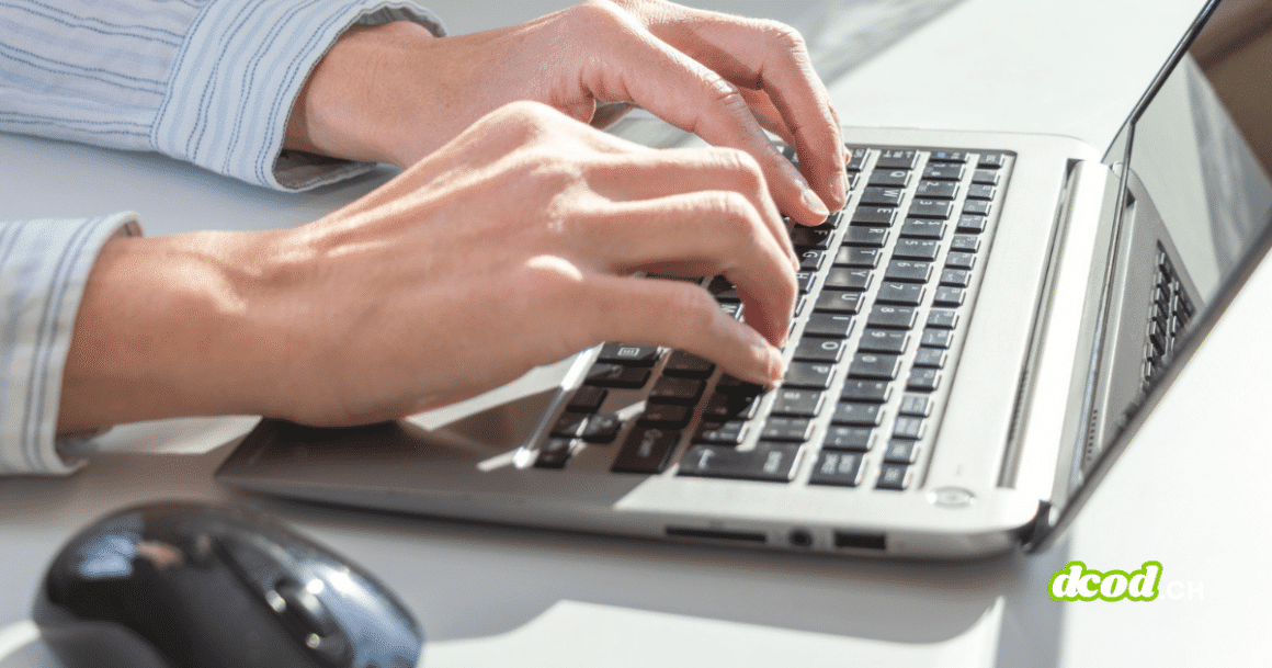 Gros plan sur des mains utilisant un ordinateur portable sur un bureau, illustrant un usage professionnel quotidien et la dépendance croissante au poste de travail numérique.