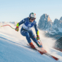 Photographie d'une skieuse alpine italienne en pleine action lors d'une descente de slalom géant, portant le dossard de Milan Cortina 2026, avec les montagnes des Dolomites en arrière-plan.
