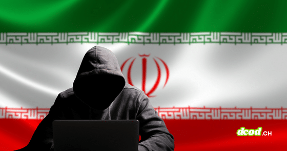 Silhouette sombre d'un pirate informatique en sweat à capuche devant un ordinateur portable, posant devant le drapeau national iranien.