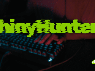 Mains d'un informaticien tapant sur un clavier rétroéclairé dans la pénombre, avec le nom du groupe cybercriminel ShinyHunters inscrit en lettres vertes stylisées.